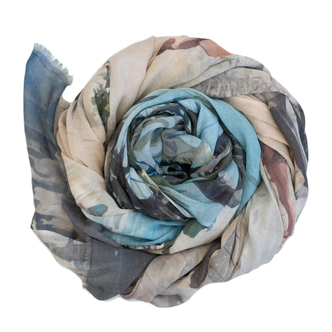 A scrolled up cotton linen scarf featuring a design of Little Cove in Noosa.