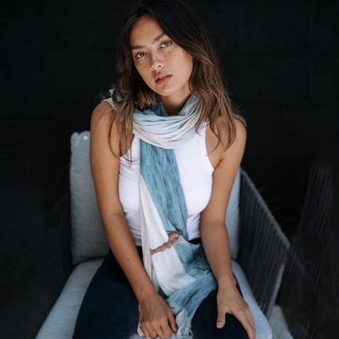 girl sitting down wearing salmon bay scarf